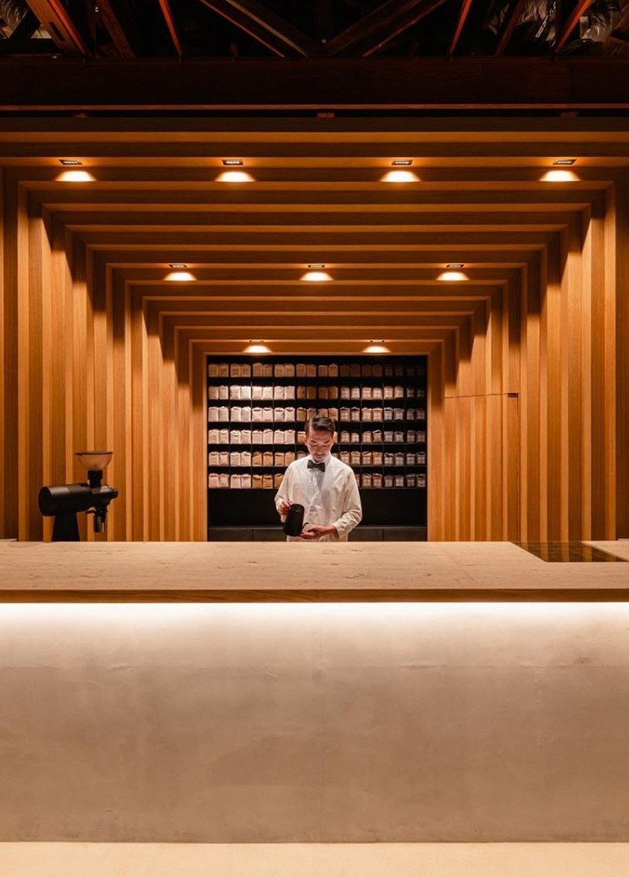 Barista welcoming guests at a café counter